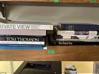 Close-up photo of assorted coffee table books on Canadian art and literature, showing titles and spines for identification.