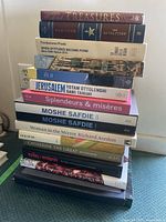 Stack of hardcover coffee table books showing spines of various art, photography and cooking titles.