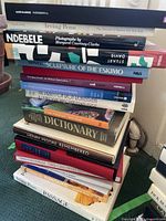 Stack of various hardcover books with visible titles focused on art, photography, Eskimo sculptures, and culture.