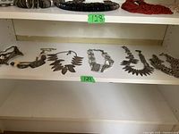 Overview of all five silver-tone necklaces on shelf