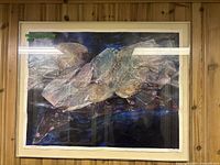 Front view of the large, metal framed abstract wall art showing overall dimensions and design.