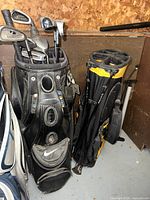 Black Nike cart bag next to black and yellow stand bag showing club tops