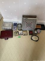 Overview of all 13 boxes and mirror arranged on carpet