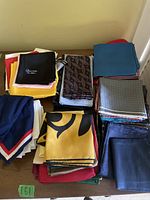 Top view showing multiple stacks of men's pocket squares and handkerchiefs with varied colors and patterns.