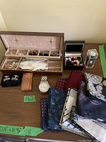 Full lot displayed on wooden surface showing pocket squares, cufflinks box, and wristwatch.