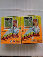Two unopened 1992 Topps baseball card boxes with colorful baseball-themed graphics.
