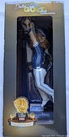 Front view of the Dalton Varsho Gold Glove Award bobblehead inside its box with clear window showing the figure in a leaping catch pose.
