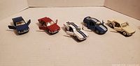 Front view of all 5 Mustang friction-powered diecast cars showing they have opening doors and detailed wheels.