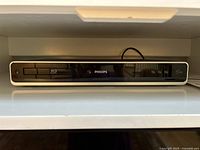 Front view of Philips Blu-ray Disc Player model BDP5013 showing power button, disc tray with Blu-ray logo, and HDMI output label.