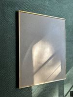 Top view of the rectangular puzzle board showing the light-colored board surface and natural wood frame.