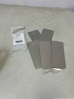 Five CWOVRS diamond sharpening plates with honeycomb surface arranged on cloth.