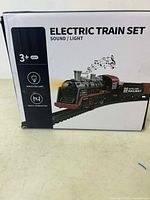 Front and side views of the original boxed electric train set package showing the train model, features including sound, light, simulated lamp, and track combination, suitable for age 3 and up.