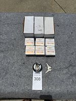 Three disc lock boxes on a surface with a single disc lock and two keys displayed in front, showing the lock design and keys.