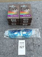 Six boxed new The Wonder Pax Eyes Masks stacked with one blue gel eye mask sealed in plastic in front.