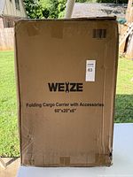 Photo of the front of the cargo carrier box showing brand WEIZE and product dimensions.