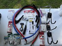 Top view showing various hand tools, sanding belts, dry wall sanding screens, hoses, and mounting hardware