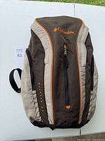 Full view of the large brown, tan, and orange Columbia backpack with multiple compartments.