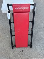 Top view of the mechanics creeper showing red padded headrest and body with 'Prosource' branding.