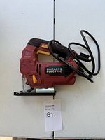 Full side view of the Chicago Electric orbital jig saw showing its red body and black handle with attached power cord.