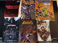 All seven books laid out, six visible titles