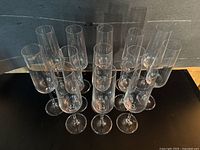 Top view showing all 13 clear glass champagne flutes arranged together