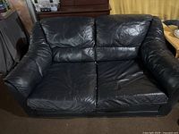 Front view of black leather loveseat