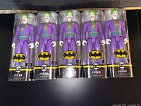 Front view of five sealed Joker figures