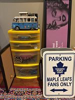 Overall lot showing VW bus, storage drawers, Marilyn Monroe print, corkboard, Maple Leafs sign