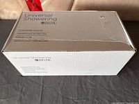 Closed retail box labeled Universal Showering by Delta