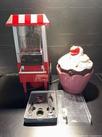 Overall shot of popcorn maker, cookie jar and wine accessory set