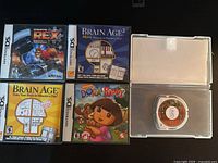Overview showing all four Nintendo DS cases and one PSP UMD disc