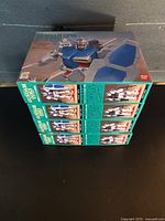 Four sealed Bandai Gundam GP01 model kit boxes stacked side view