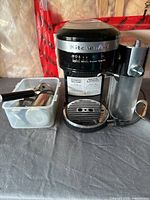 KitchenAid espresso machine with accessory bin on table