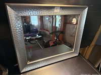 Front view of mirror with hammered silver frame