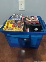 Blue tote showing assortment of media with Jumpin’ Jack Flash VHS on top