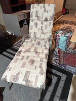 Front view of reclining lounge chair showcasing cushion pattern and metal frame