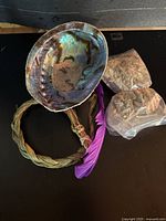 Entire smudge kit including abalone shell, sweetgrass braid, sage bags, purple feather
