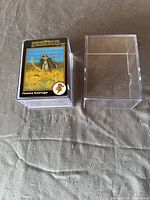 Stack of cards inside plastic case, front card "Flownnan Tarehuage" visible