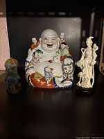 Front view of the three Chinese figurines together.