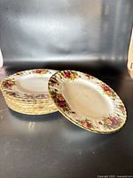 Stack of the 8 Royal Albert Old Country Roses plates showing floral rims and edges