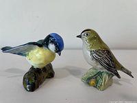 Front and side view of the pair of bird figurines showing Beswick blue tit and brown bird.