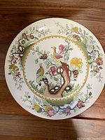 Full top view of the Spode English decorative plate showing bird and floral design with color and detail.