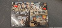 Two DVD box sets of Rat Patrol seasons 1 and 2 displayed side by side on a dark surface, showing military-themed cover illustrations.