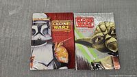 Front covers of the two DVD box sets. Season 1 with Clone Trooper art and red theme, Season 2 with Yoda art and green theme.