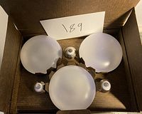 Six frosted round LED light bulbs inside a cardboard box.