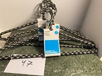5-pack of braided fabric clothes hangers by Room Essentials, new condition, stacked together with packaging label visible.