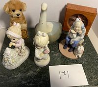 Overall lot showing all figurines including the plush dog, ceramic goose, Laredo Clown, and wooden box figurine