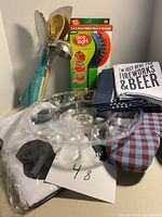 Photo showing the full lot including Slice Right packaging, kitchen utensils, oven mitt, towels and serving tray.