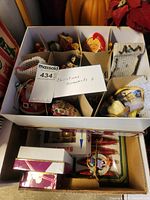 Overview photo of two boxes filled with assorted Christmas ornaments showing variety of ornament types and materials.