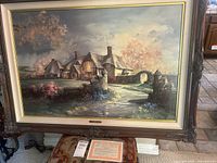 Front view of the framed print on display with certificate below